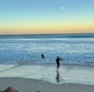 Surfers heading in for surf session at St Francis Bay | Ocean Bay recovery